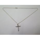 A 9ct white gold diamond cross 0.40ct, 4.3cm long, on a 9ct yellow gold 52cm long chain, total