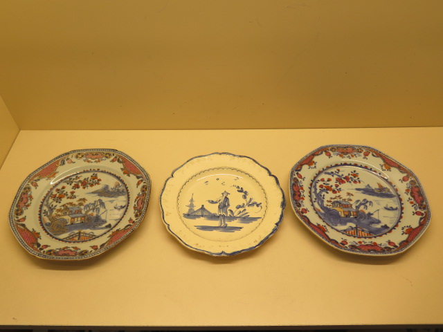 Two famille rose decorated plates, 23cm wide, both with chips to rims and a pointing chinaman