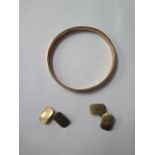 A pair of 9ct gold cufflinks and 9ct gold hollow bangle, total approx 11.9 grams, denting to