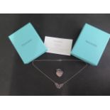 A Tiffany & Co silver heart pendant and a Tiffany butterfly necklace, 40cm long, both with boxes and