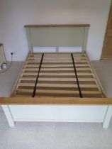 A five foot double slatted bedstead, the headboard 111cm tall