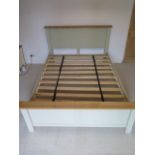 A five foot double slatted bedstead, the headboard 111cm tall