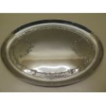 An embossed oval silver tray, London 1909/10 William Comyns no A789, 30cm x 23cm, approx 11.4 troy