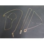 A 9ct gold pendant on chain, two broken 9ct gold chains and a 9ct chain with two 14 ct pendants,