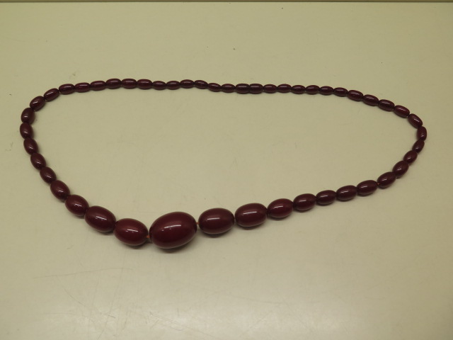 A large cherry amber type bead necklace, 72cm long, largest bead 3cm x 2.2cm, total weight approx 65