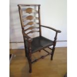 An antique, circa 1800, ash and elm ladder back elbow chair with leather seat in polished condition,