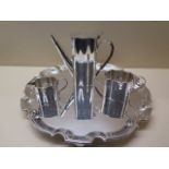 A silver plated tray, 31cm diameter, with a three piece plated coffee set engraving to coffee pot