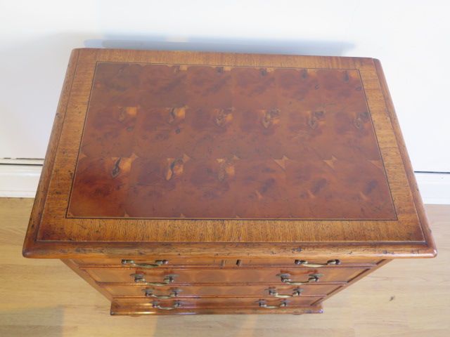 A yew oyster veneer chest of small proportions with two short over three long drawers on turned feet - Image 2 of 5