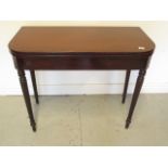 A 19th century mahogany fold over card table on turned legs, 75cm x 92cm