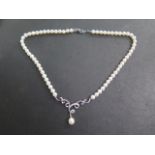 An 18ct white gold diamond and pearl necklace, 42cm long, drop pearl approx 6mm, marked 18K 750,