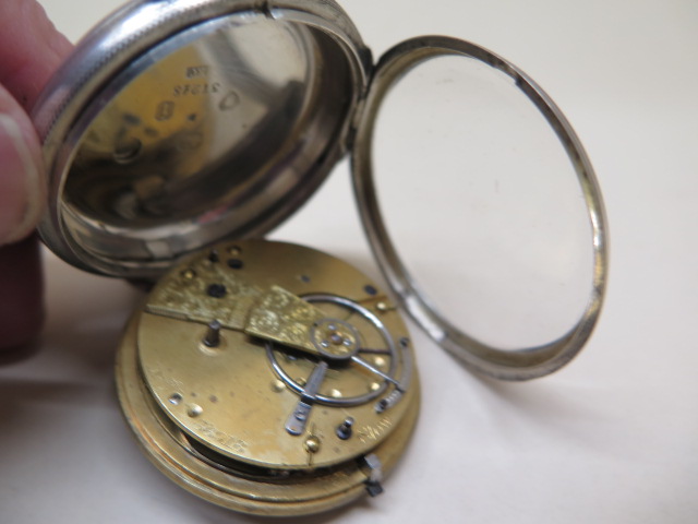 A silver pocket watch with silver dial, 4.6cm case, running order, some scratches to dial, with key - Image 4 of 4