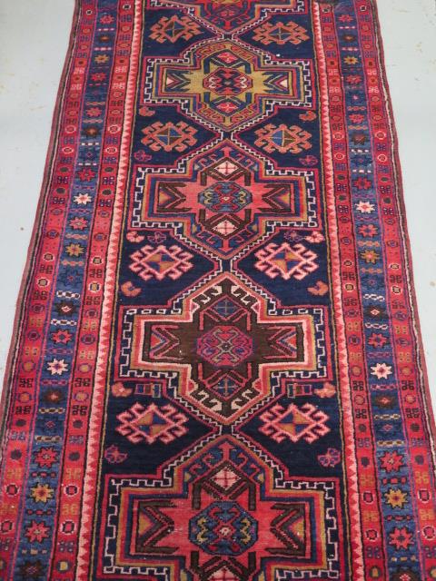 A blue and red ground hand woven runner with a cross door design, some wear but colours bright, - Image 3 of 3