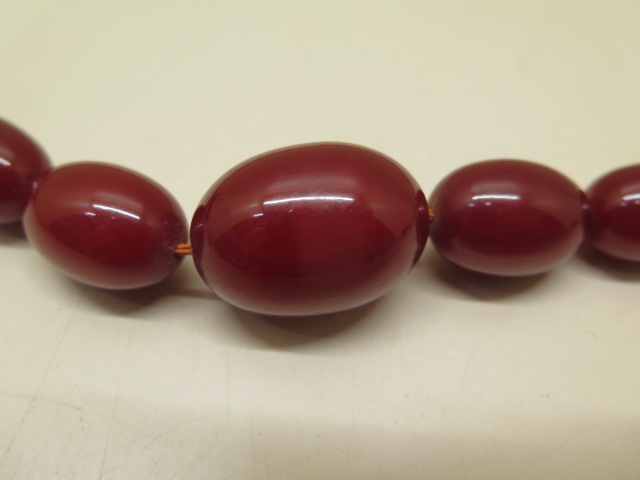 A large cherry amber type bead necklace, 72cm long, largest bead 3cm x 2.2cm, total weight approx 65 - Image 2 of 4