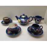 A Moorcroft teapot, a sugar bowl, milk jug, two cups, three saucers, all have crazing, chip to one