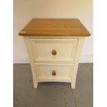 A painted two drawer bedside chest with a wooden effect top