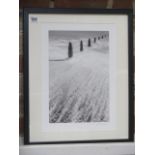 An L Munro signed black and white photographic print of a seascape scene, frame size 53cm x 43cm,