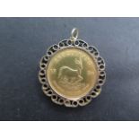 A fine gold 1oz Krugerrand coin, dated 1974, in a hallmarked 9ct pendant mount, total weight