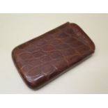 A crocodile cigar case in polished condition, 9.5cm wide and 16cm closed