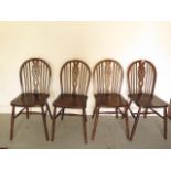 A set of four early 20th century wheelback dining chairs in good polished condition
