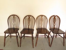 A set of four early 20th century wheelback dining chairs in good polished condition