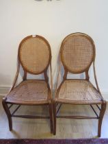 A pair of walnut side chairs with caned seats and backs, one seat needs recaning otherwise good