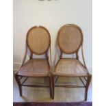 A pair of walnut side chairs with caned seats and backs, one seat needs recaning otherwise good