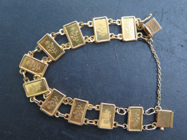 A gold bracelet set with 10 Suisse 1g 999.9 fine gold ingots, bracelet tests to approx 18ct, total