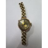 A 9ct yellow gold manual wind ladies wristwatch on a plated strap, not working, approx total