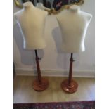 A pair of 20th century calico covered tailors busts on turned bases, adjustable stems, labels for '