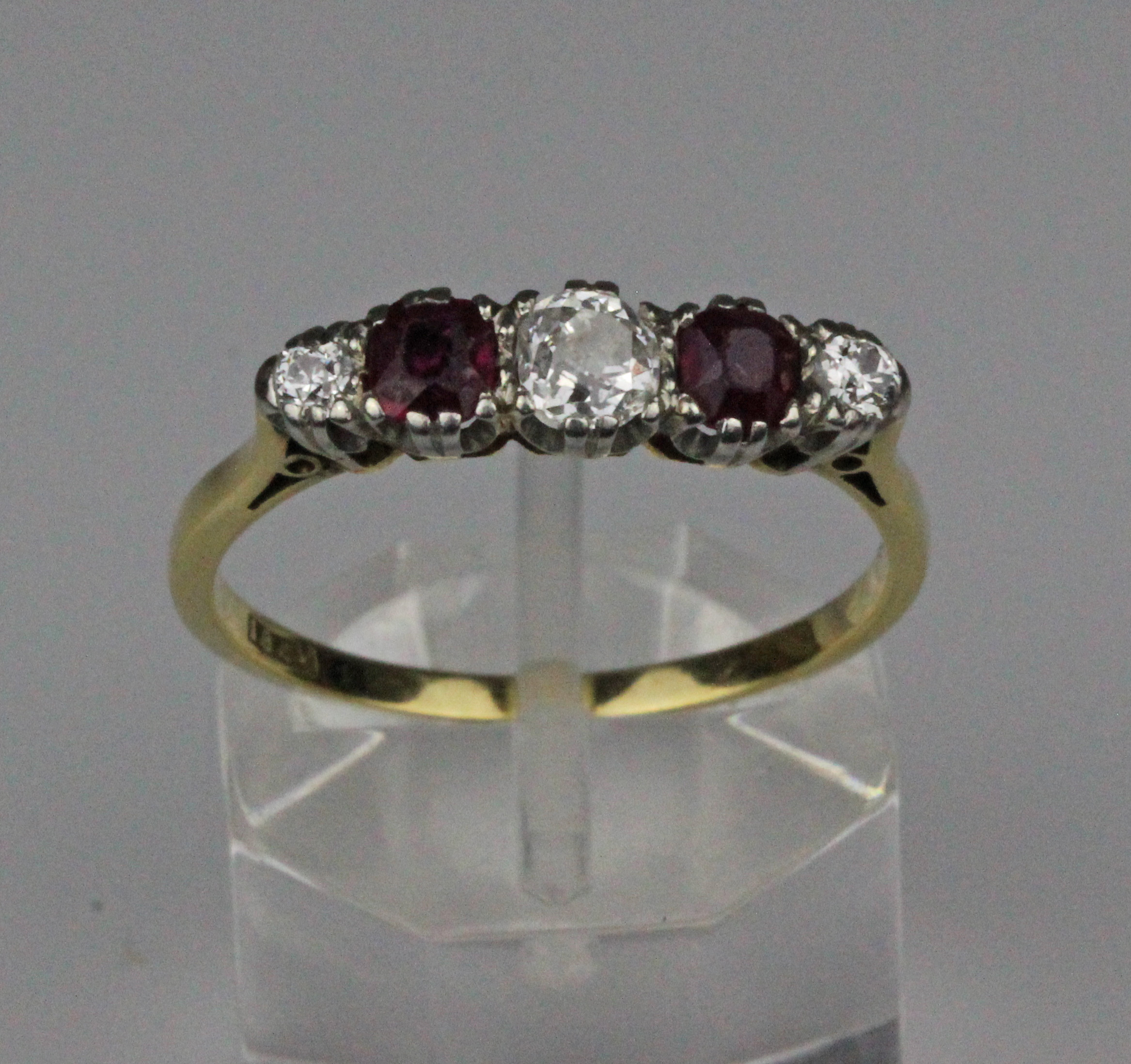 A ruby and diamond five stone ring, the claw set central old brilliant cut diamond 4.1mm x 4mm