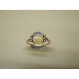A yellow metal ladies dress ring incorporating a single cabochon cut pale opal, size approx 10mm x