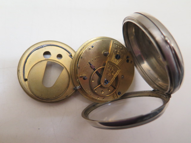 A silver pocket watch with 5.2cm case in running order, generally good some wear to case, with key - Image 4 of 4
