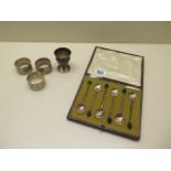 Three silver napkin rings, a silver eggcup and a boxed set of six silver coffee spoons, total weight