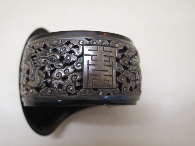 A Chinese folding tortoiseshell and white metal bangle set with a green jade cabouchon, 7cm wide - Image 2 of 5