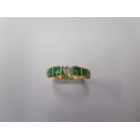 A hallmarked 18ct yellow gold seven stone emerald and diamond ring, size L, in good condition,