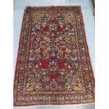 A hand knotted woollen Lilian rug, 2.10m x 1.40m, in good condition