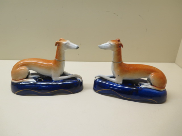 A pair of Staffordshire dog inkwells, 17cm long, both with crazing, no obvious damage, some firing