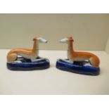 A pair of Staffordshire dog inkwells, 17cm long, both with crazing, no obvious damage, some firing
