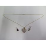 A yellow gold 9ct pendant on 9ct chain and two 9ct white gold pendants, total weight approx 7.4