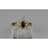 An 18ct gold sapphire and diamond cluster ring, the claw set central oval faceted sapphire, estimate