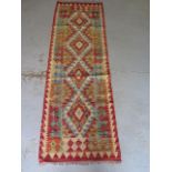 A hand knotted woollen Chobi Kilim runner, 203cm x 66cm