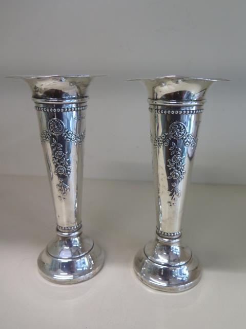 A pair of silver vases with weighted bases, 18.5cm tall, some denting and bending but nice