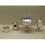 A silver mustard with plated spoon, a silver engraved jug, a silver trophy footed bowl and a