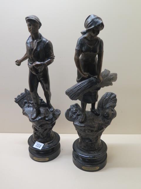 A pair of Spelter figures, 43cm tall, showing man sowing corn and lady binding corn, marked