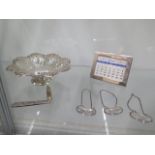 A silver sweetmeat dish, a silver Tiffany calendar, three silver spirit labels and a silver fruit