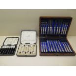 A boxed silver handled butter knife and fork 12 setting set and two boxed sets of six silver