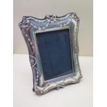 A silver photo frame with easel back, 21cm x 16cm