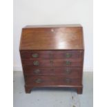 A Georgian mahogany four drawer bureau of small proportions with a fitted interior, 95cm tall x 86cm