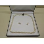 A good quality string of Mikimoto pearls with a 14ct yellow gold raised clasp, 56cm long, approx