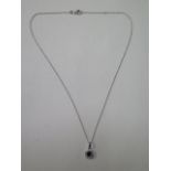 An 18ct white gold sapphire and diamond pendant and chain, chain 16" long, pendant 9mm wide, in good